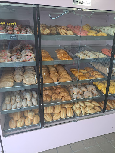 Bakery cases filled with baked goods including cookies, empanadas, and cookies